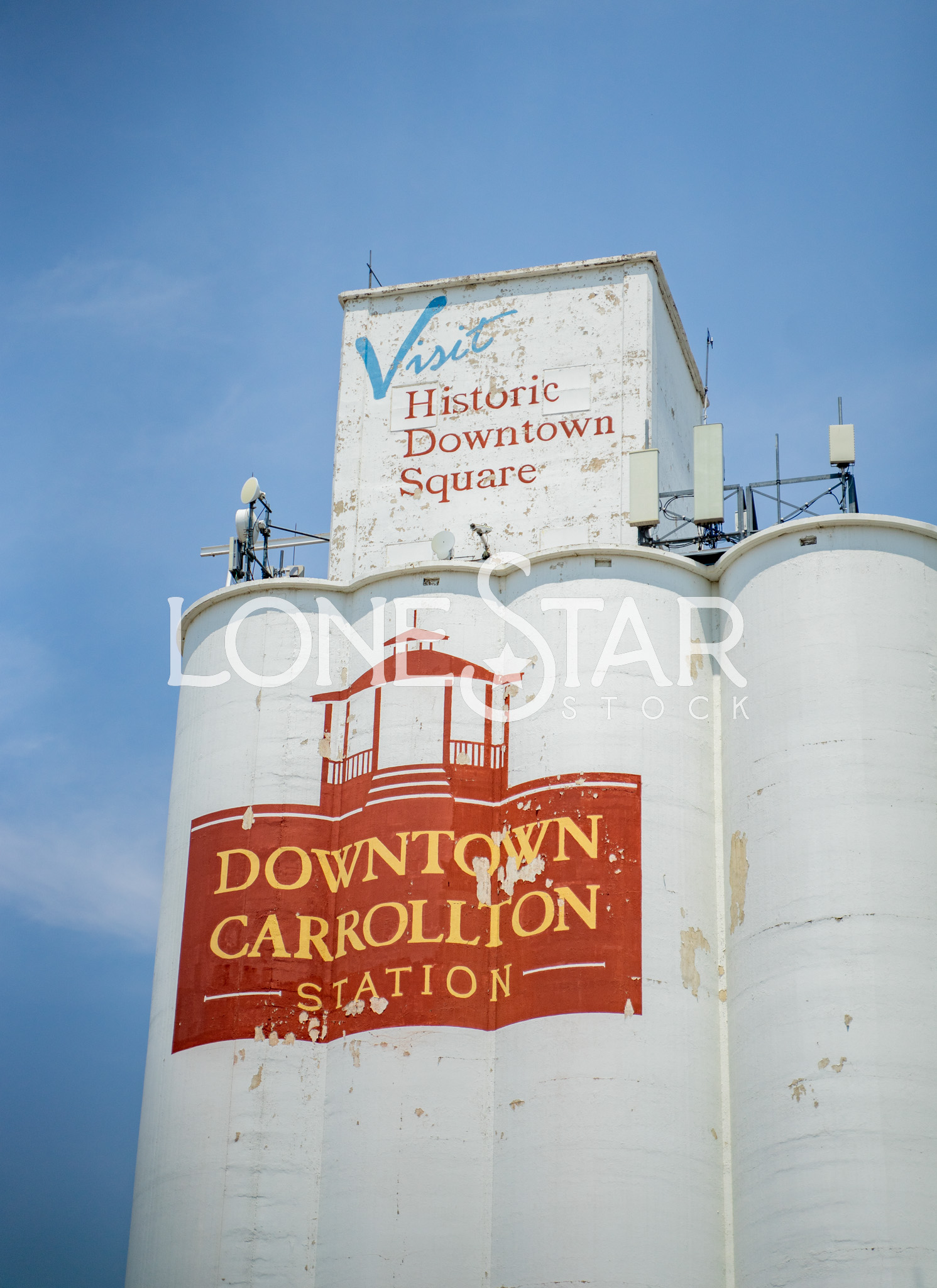 Preview of Close Up of Downtown Carrollton Station Silos in Historic Downtown with Cloudy Sky in Background